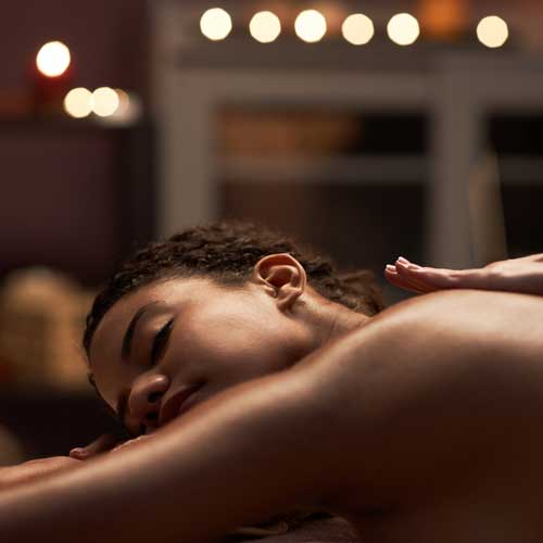 A woman laying on her stomach on a massage table.