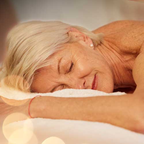 A woman laying on her stomach on a massage table.